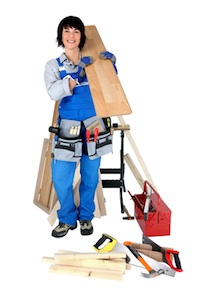 Tradeswoman posing with her tools and building supplies