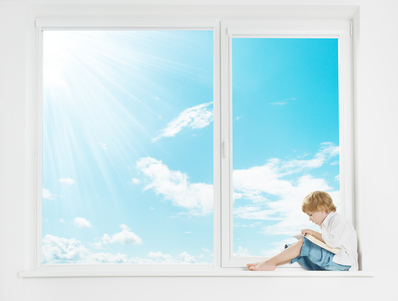 Window sunshine sky. Child on windowsill reading book.