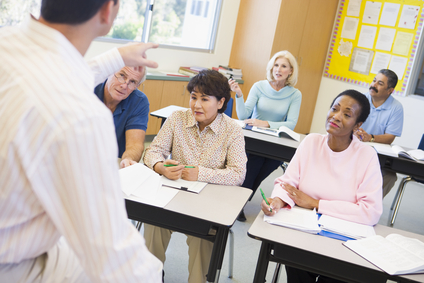 Mature students and their teacher in a classroom