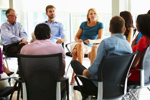 Multi-Cultural Office Staff Sitting Having Meeting Together