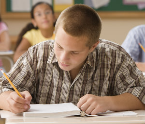 Student writing in class 300