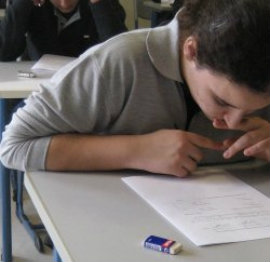 girl looking down at paper