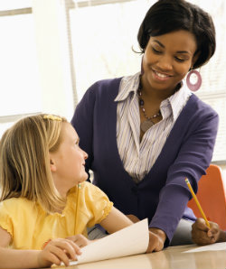 young girl w tchr by desk 250