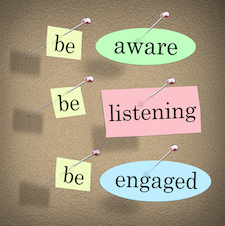 Be Aware, Listening and Engaged words on papers pinned to a bulletin or message board to illustrate