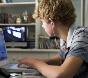 boy-in-bedroom-using-lap-4136945